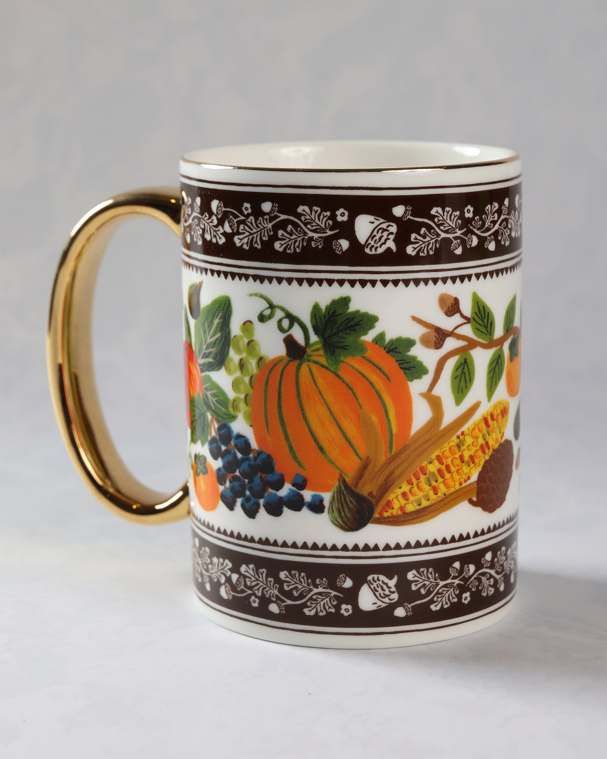 Back view of the harvest porcelain mug showing a pumpkin, grapes, corn, berries, and leafy borders.