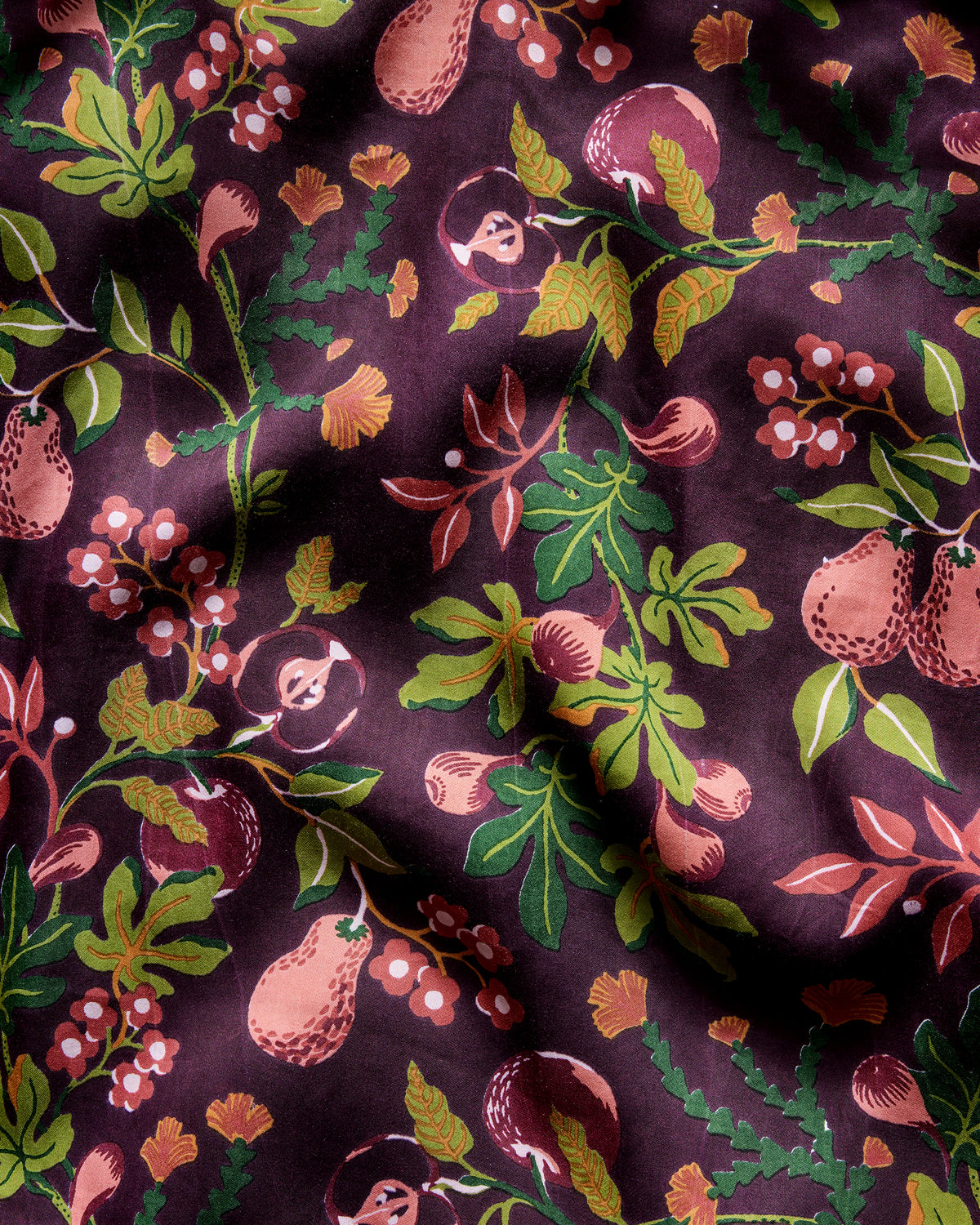 Close-up of the plum Pomme & Poire pajama print with pears, apples, berries, leaves, and flowers.
