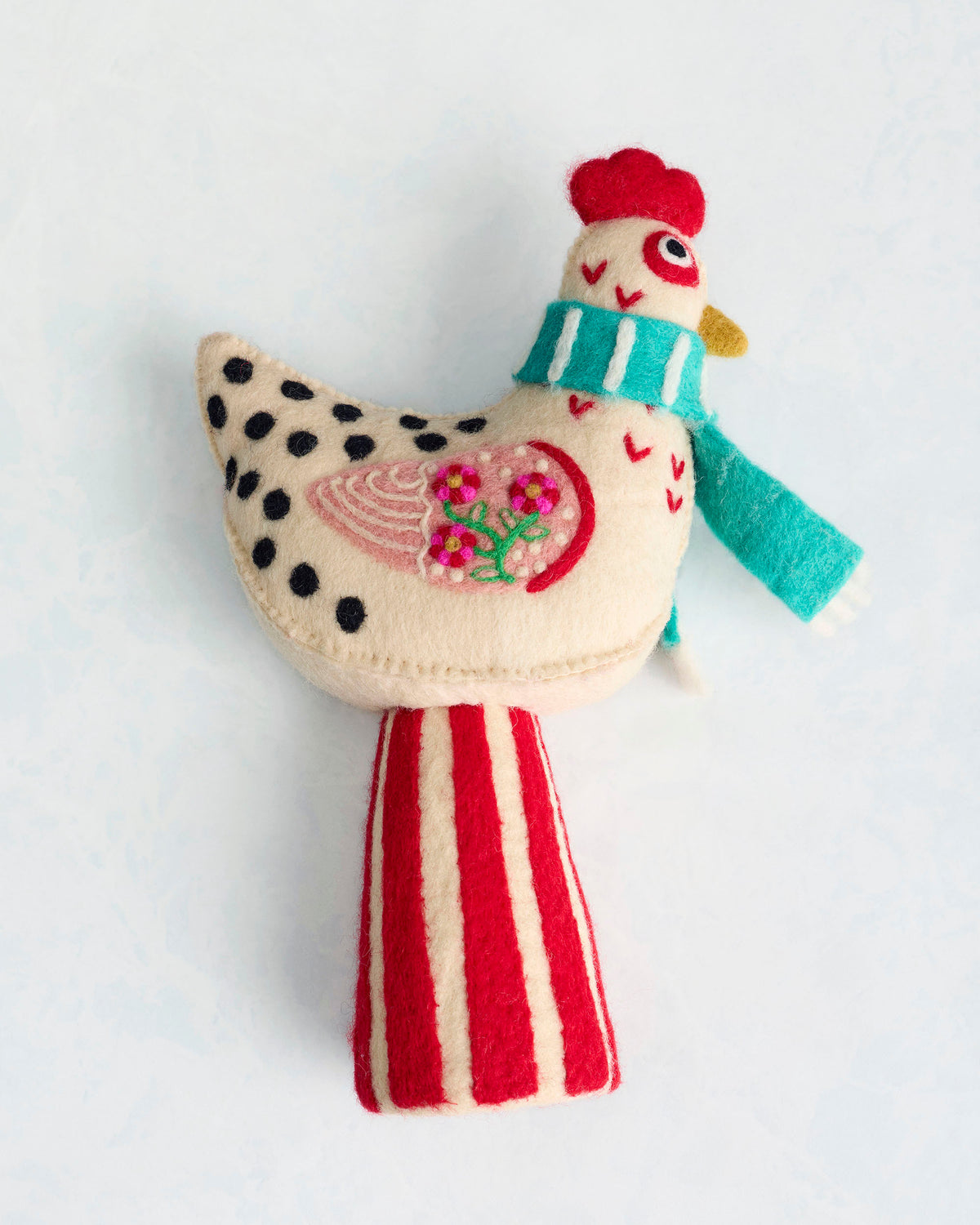 Felt chicken tree topper wearing a turquoise scarf, shown from the opposite side with a floral wing design and red-and-cream striped tail.