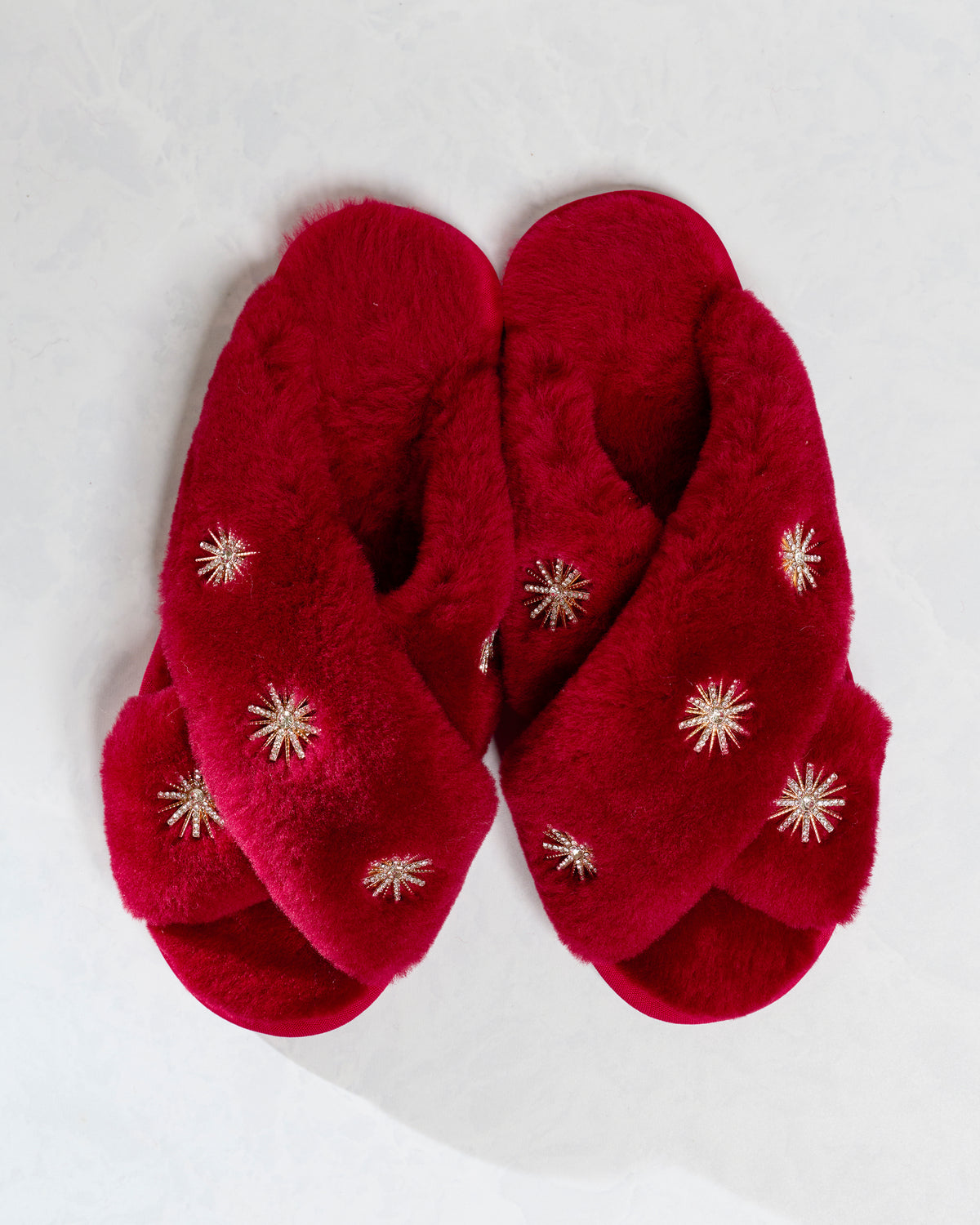 Wine sheepskin slippers with rhinestone embellishments, shown as a pair from above.
