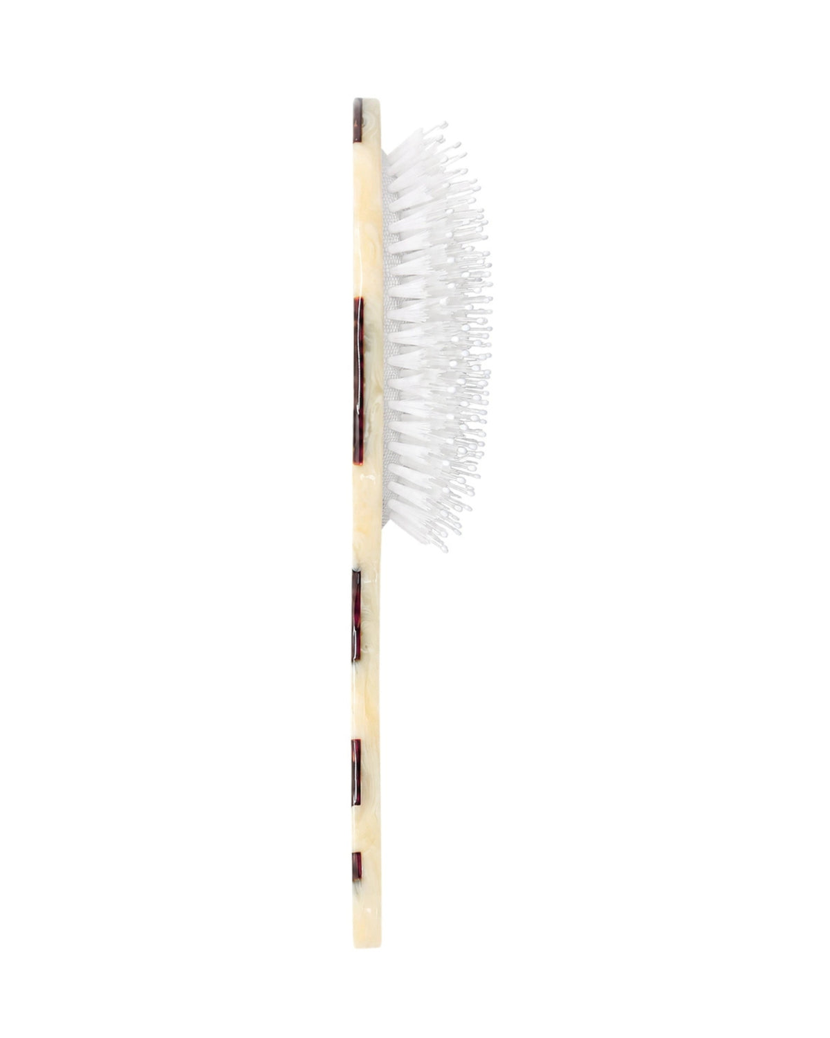 Side view of a hand-painted hair brush showing the depth of its white bristles and brown-and-cream handle.