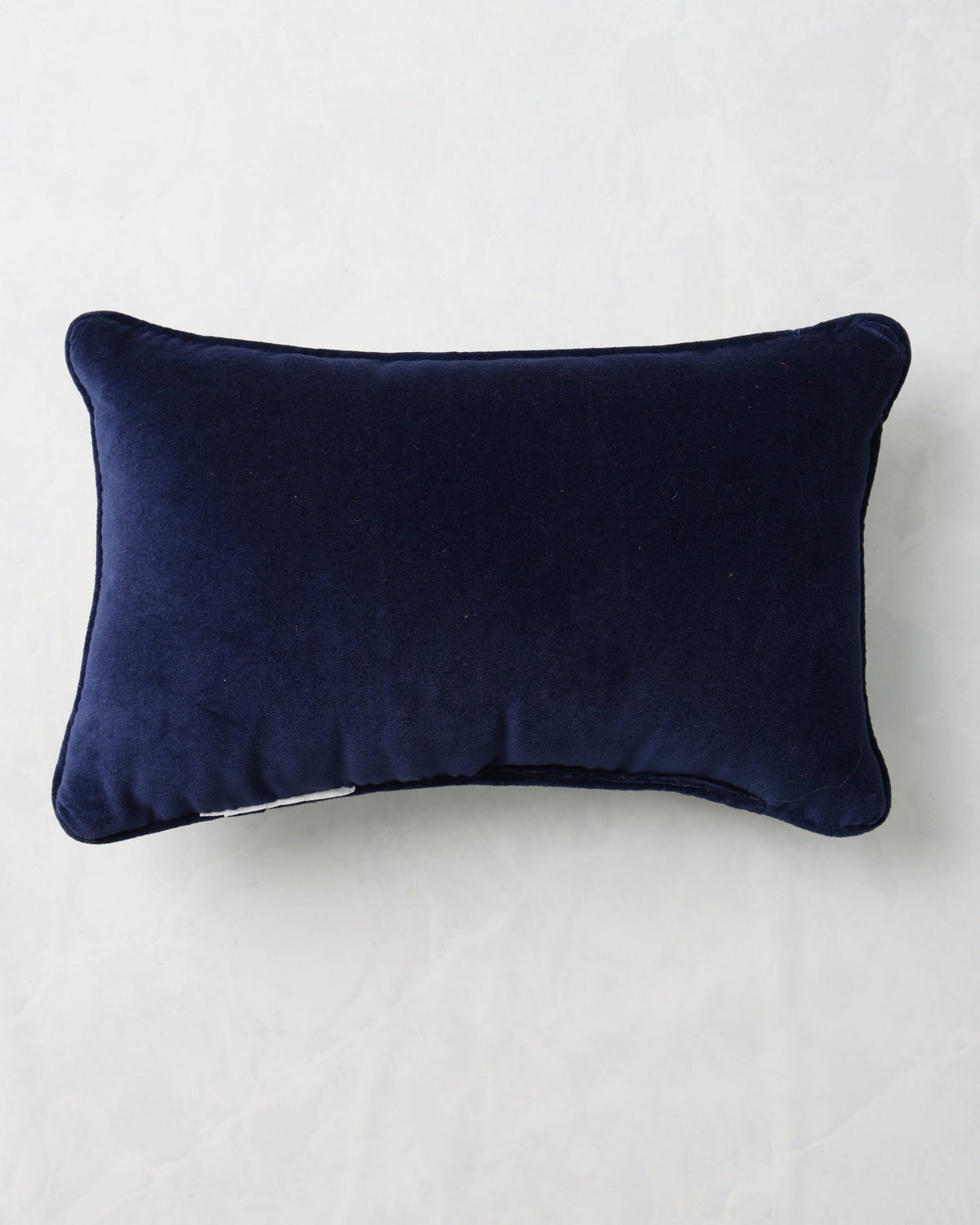 Back of the ivory Hanukkah pillow in dark navy fabric.