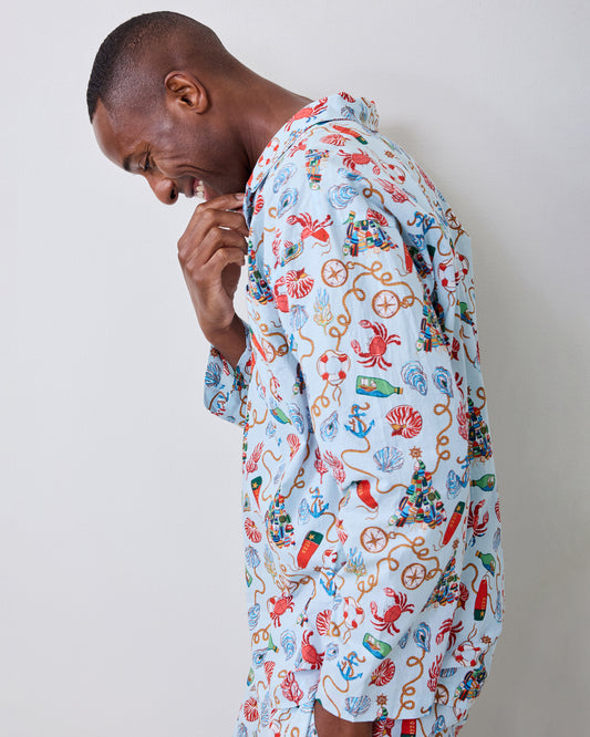 Side view of a person wearing the Holidays Ahoy long pajama set with a button-front top and nautical print.