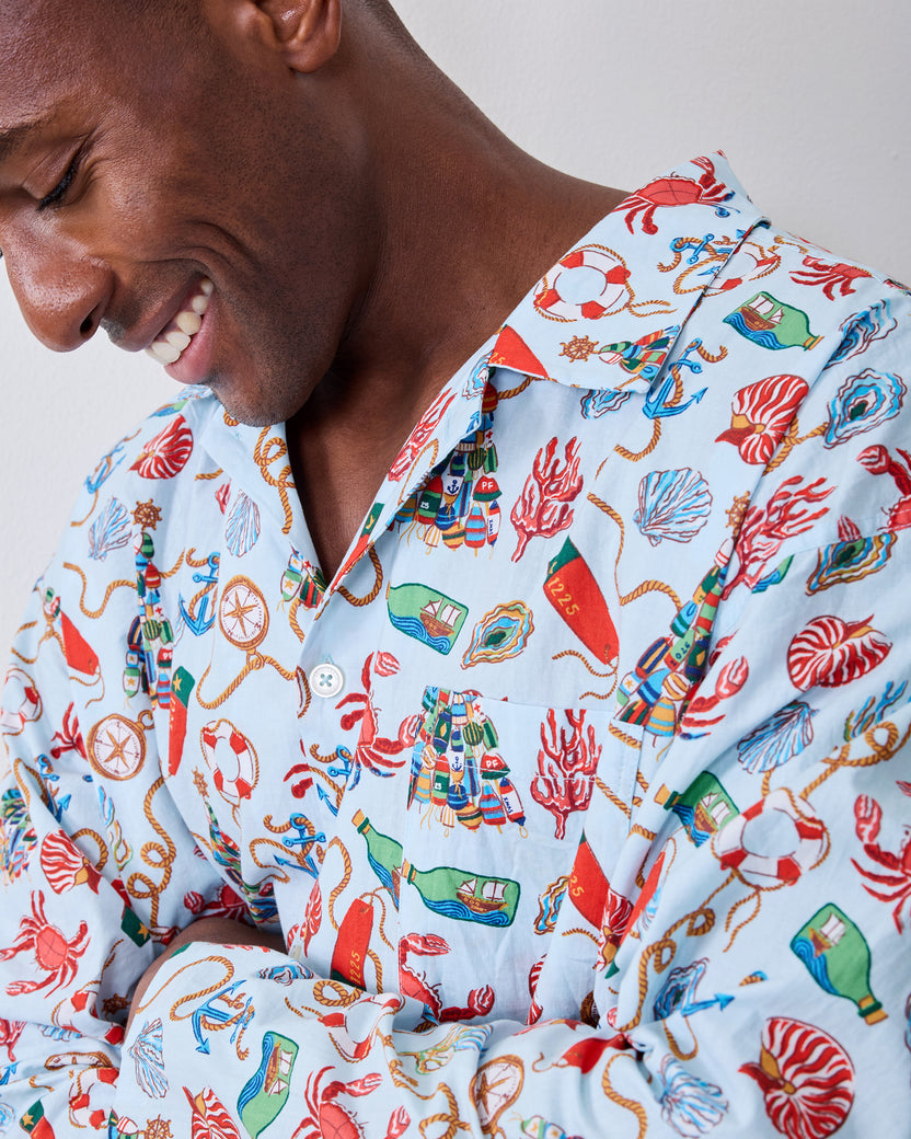 Close-up of the men's Holidays Ahoy pajama top showing the collar, chest pocket, buttons, and nautical holiday print.
