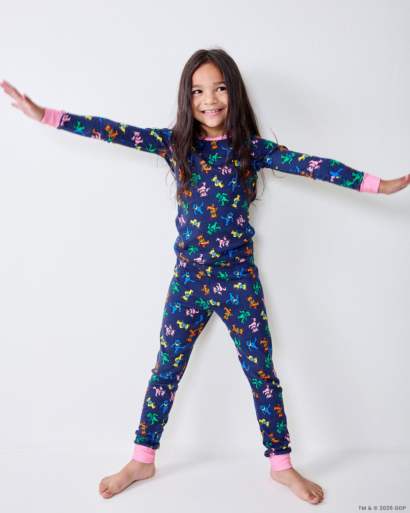 Child wearing the Dancing Bears kids pajama set with arms outstretched.