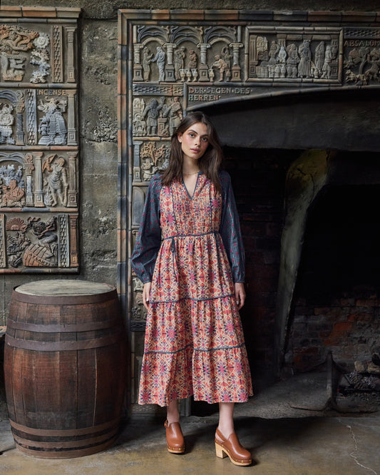 Front view of the Winged Tapestry Eden Dress with a tiered floral-print skirt and blue patterned sleeves.