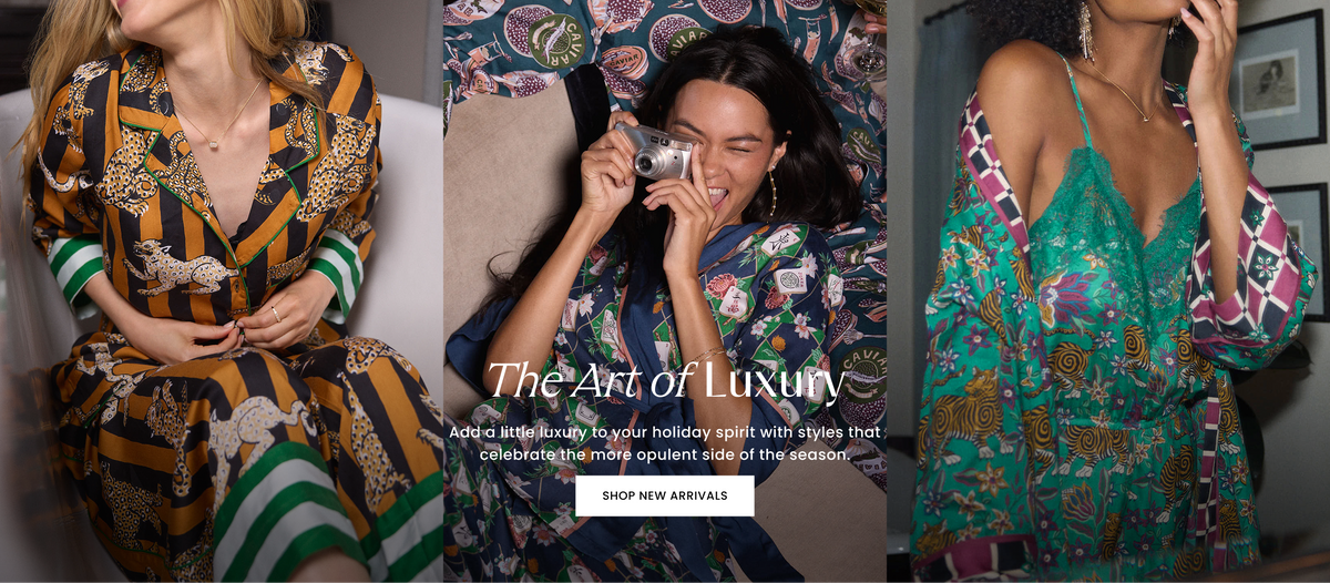 Three-panel fashion banner showing people in patterned clothing, including a central person holding a compact camera, with text reading “The Art of Luxury,” “Add a little luxury to your holiday spirit with styles that celebrate the more opulent side of the season,” and “SHOP NEW ARRIVALS.”