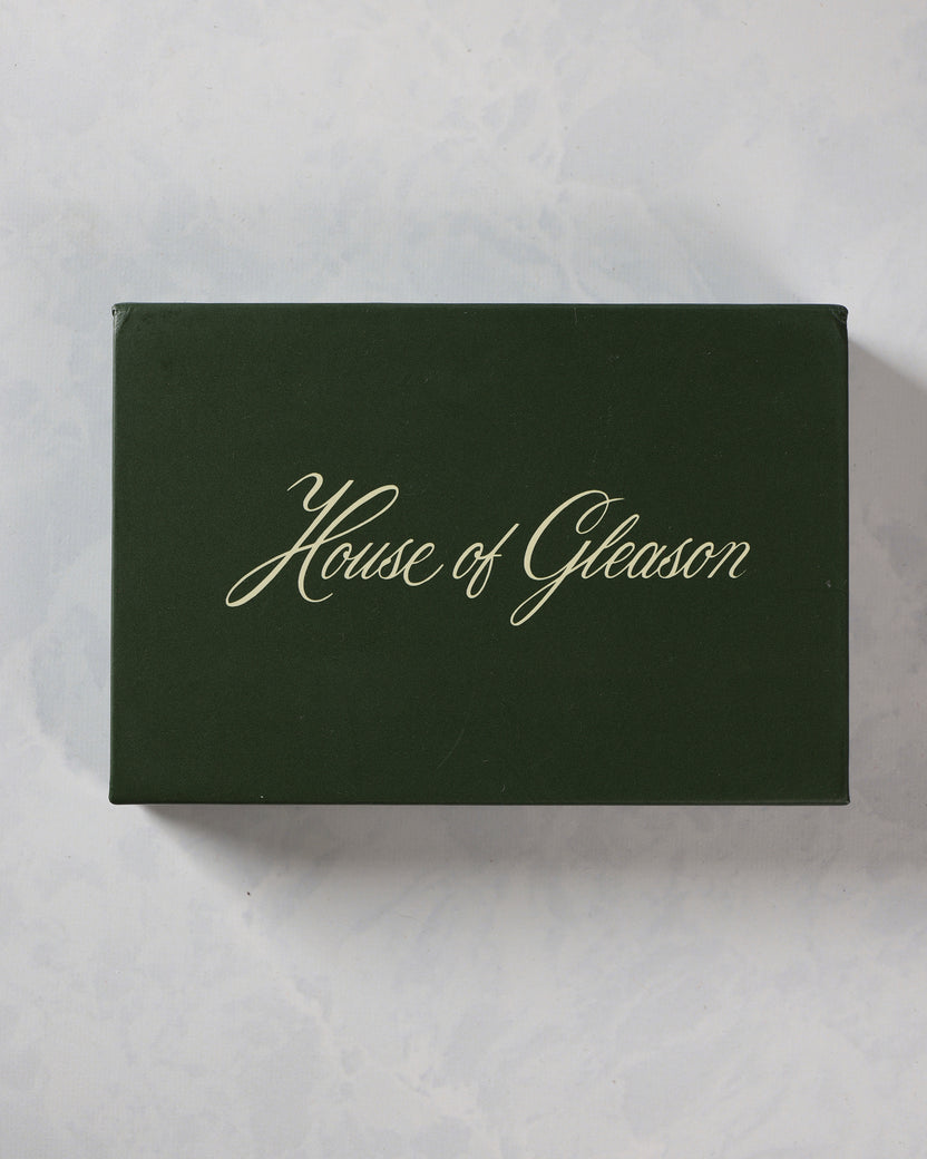 Closed dark green presentation box labeled “House of Gleason.”