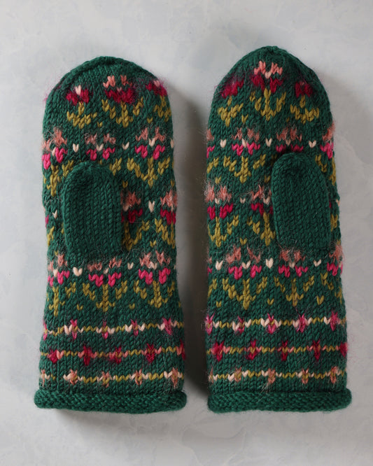 Pair of dark green knitted mittens with pink, red, yellow, and white floral patterns and thumb openings.