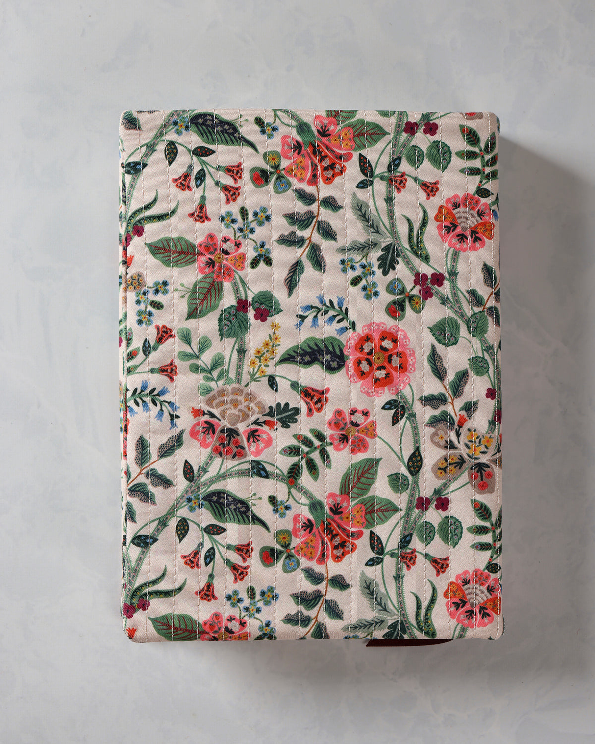 Closed Gracie quilted journal with a multicolor floral cover pattern.