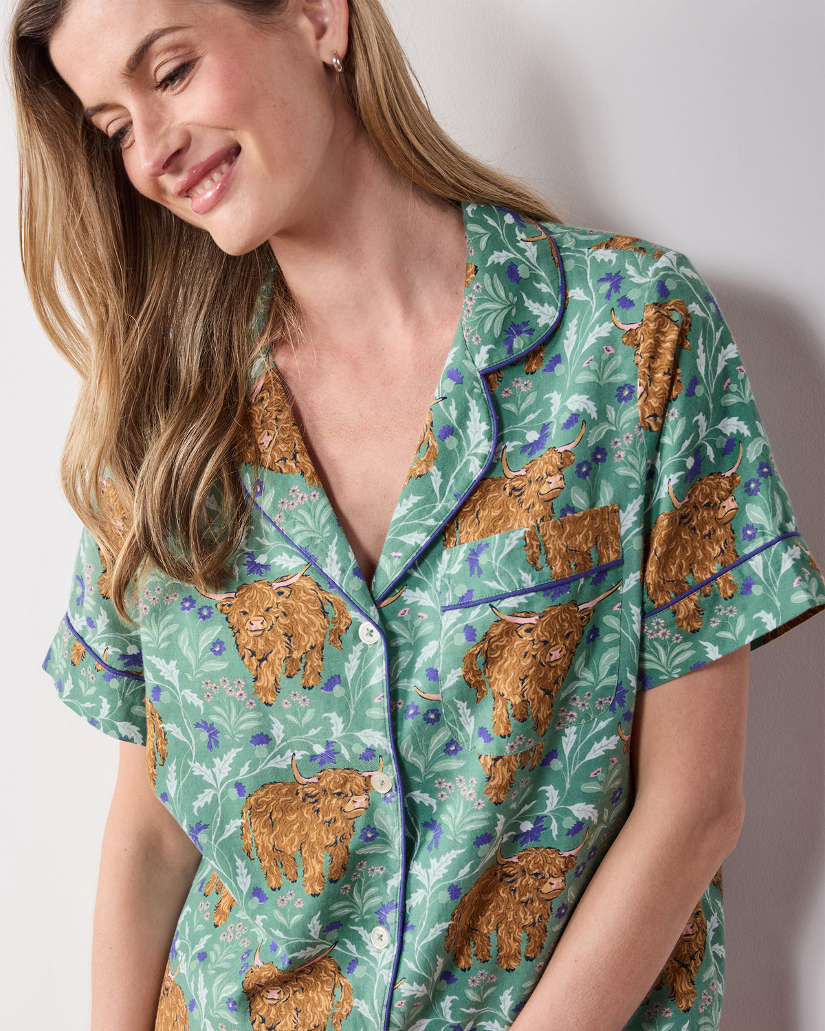 Close view of the Soft Thistle Highland Cows pajama top with contrast piping, buttons, and chest pocket.