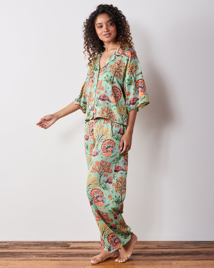 Front three-quarter view of the Soft Sage Turkey Trot Wildest Dreams pajama set with a cropped short-sleeve top and matching wide-leg pants.