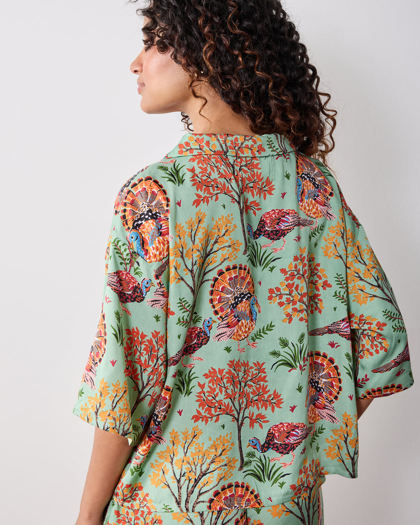 Back view of the Soft Sage Turkey Trot Wildest Dreams pajama set, showing the dropped-shoulder top and matching wide-leg pants with a turkey-and-foliage print.