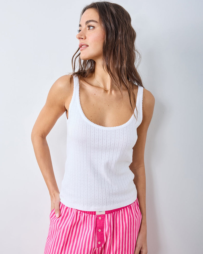 Three-quarter view of the white Esme tank top with a scoop neckline, wide straps, and vertical pointelle detailing.