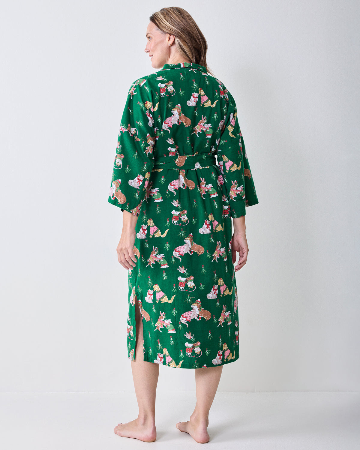 Back view of the green Mistletoe Kiss flannel long robe showing the holiday critter print, waist belt, and side slit.