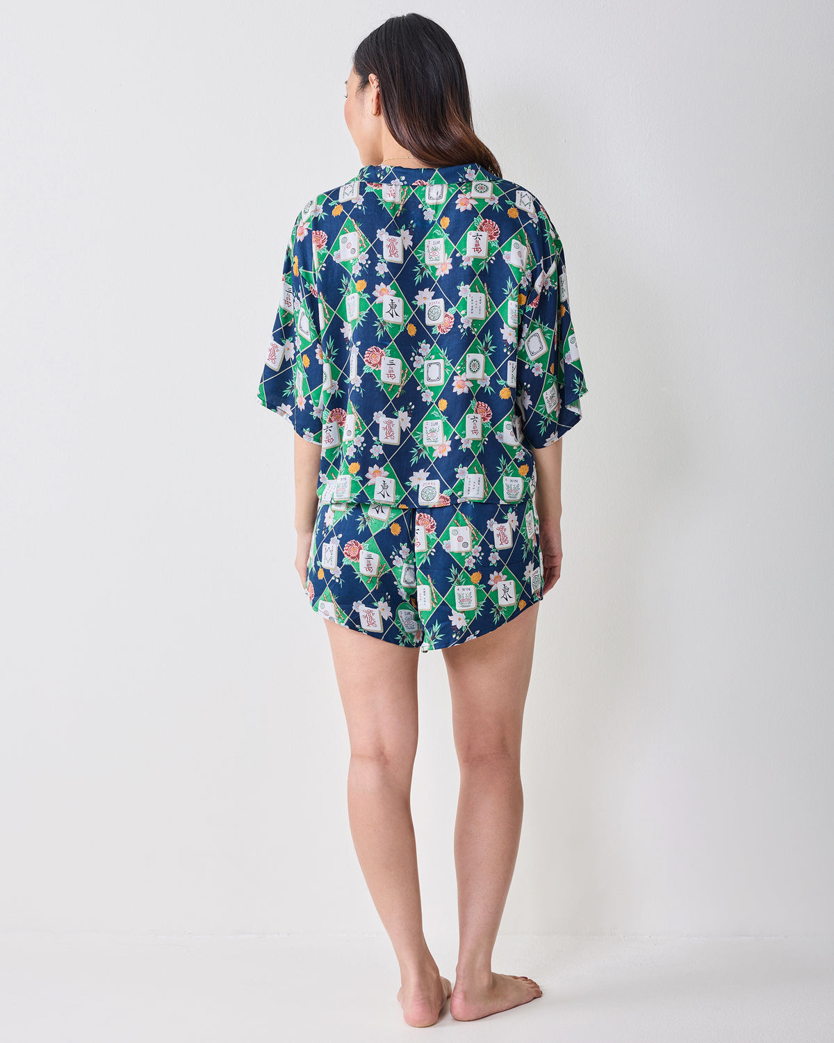 Back view of the Mahj Garden Eco Satin Sweet Dreams Set in Wintergreen, showing the matching short-sleeved top and shorts with a floral mahjong-tile print.