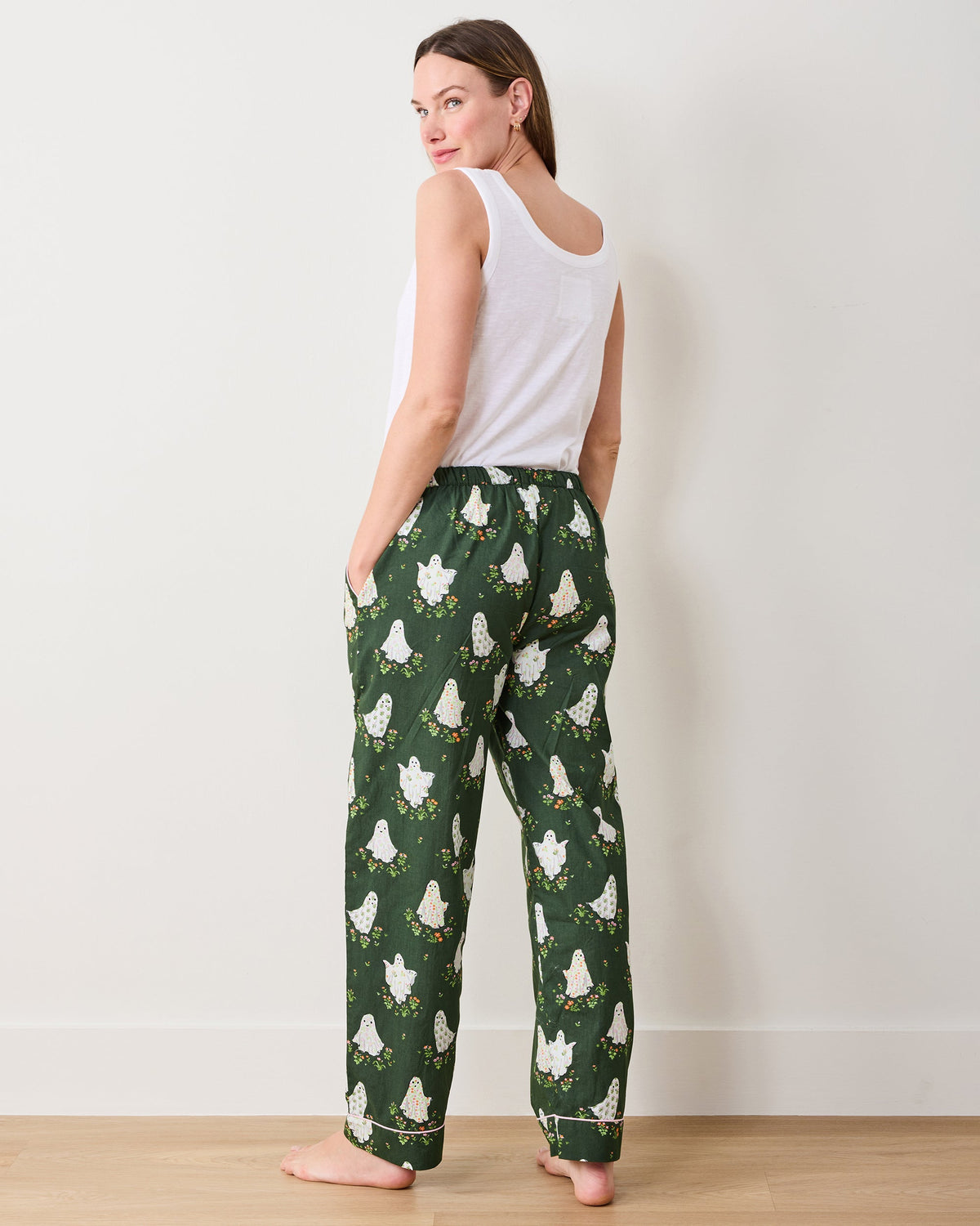 Back view of Gardening Ghosts pajama pants showing the full-length legs, pockets, cuffs, and ghost-and-flower print.