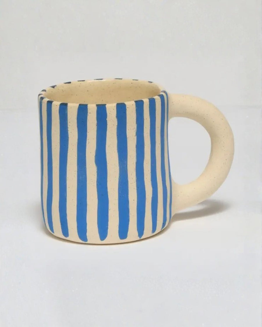Ceramic mug with hand-painted vertical blue stripes and a plain handle.