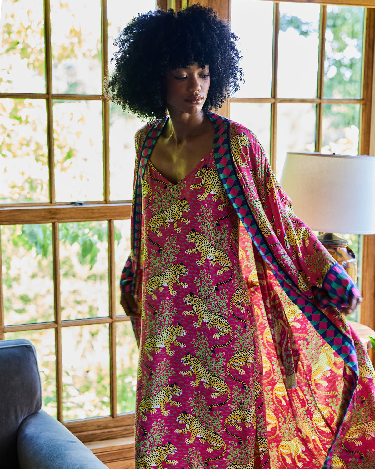 Person wearing the hot pink leopard-print robe open over a matching nightie, showing the contrasting geometric trim