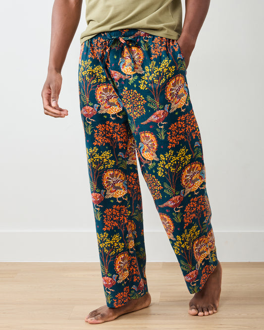 Back view of the navy Turkey Trot long pajama pants with colorful turkey and autumn foliage print, shown with a drawstring waistband and pockets.