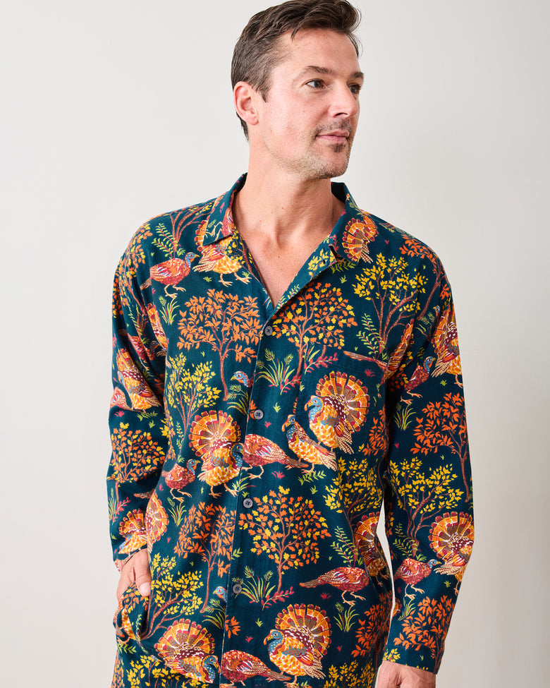 Close front view of the navy Turkey Trot long pajama shirt with colorful turkey and autumn foliage print.