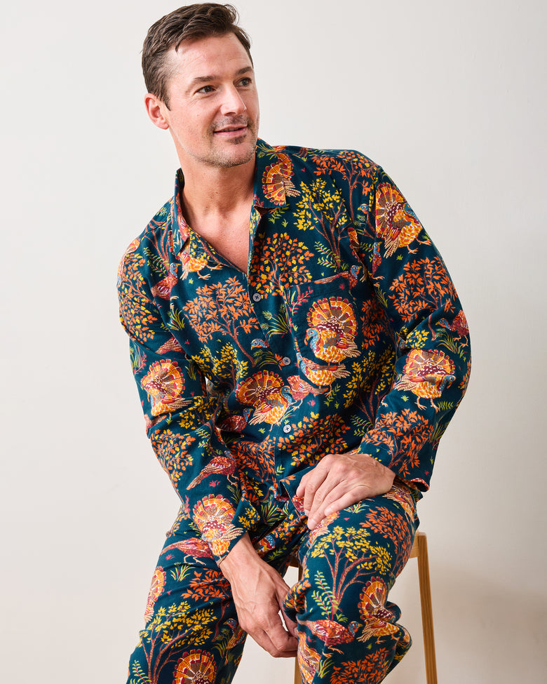 Three-quarter view of the Turkey Trot navy long pajama set with a button-front shirt and matching turkey-and-floral print pants.