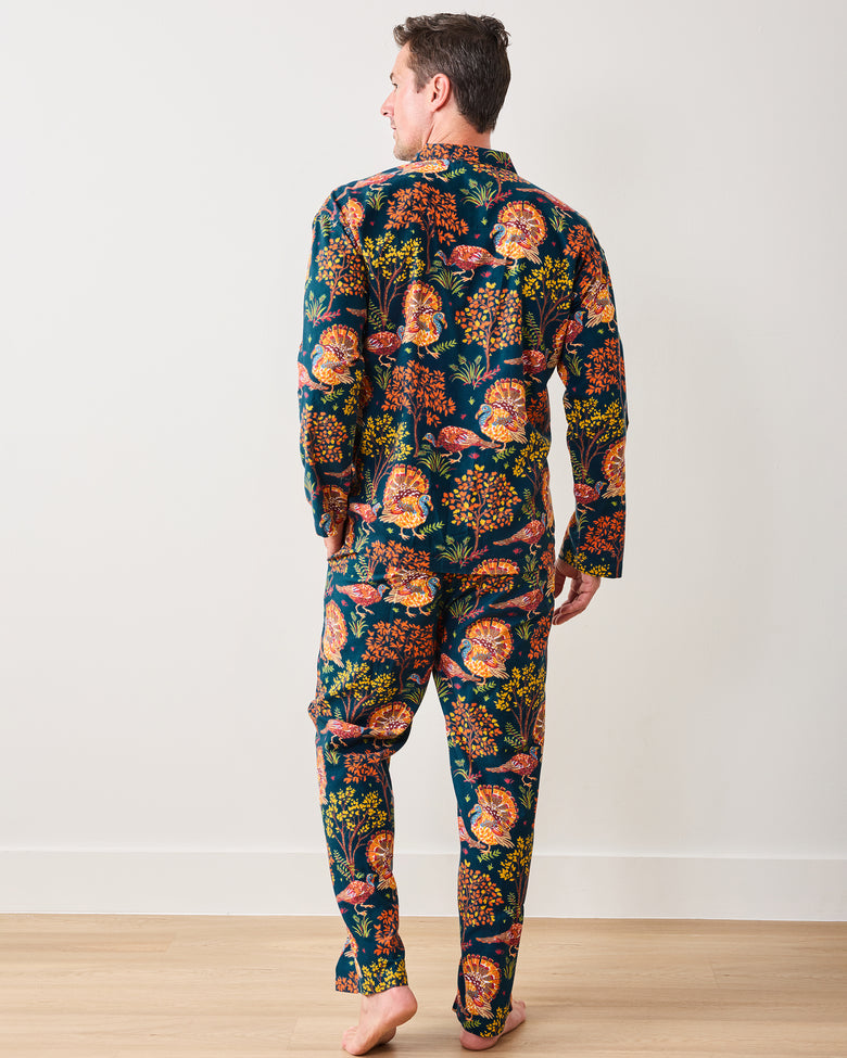 Back view of the Turkey Trot navy long pajama set with the colorful turkey-and-floral print across the shirt and pants.