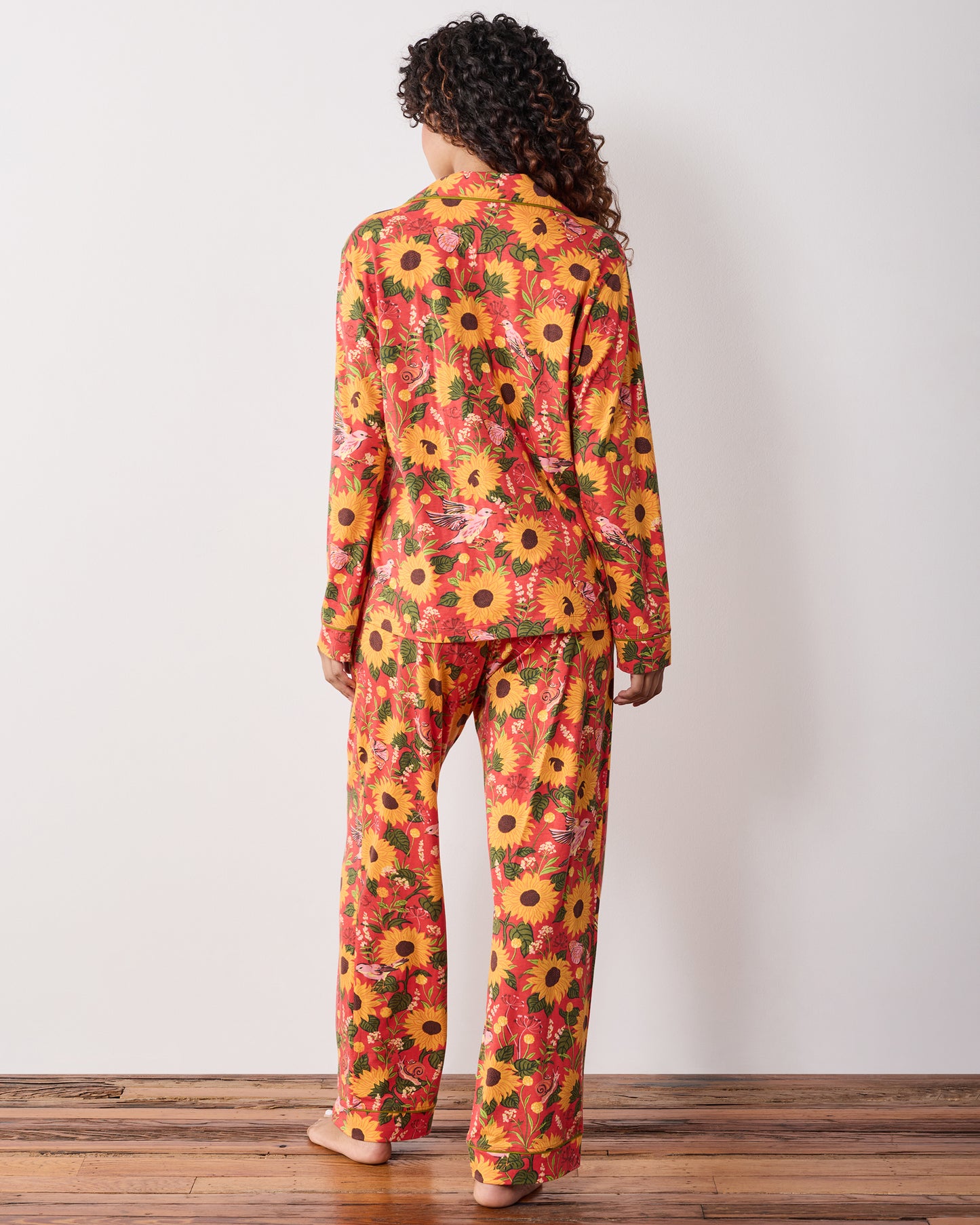 Back view of the orange Autumn Sunflowers long pajama set with a matching button-front top and full-length pants.