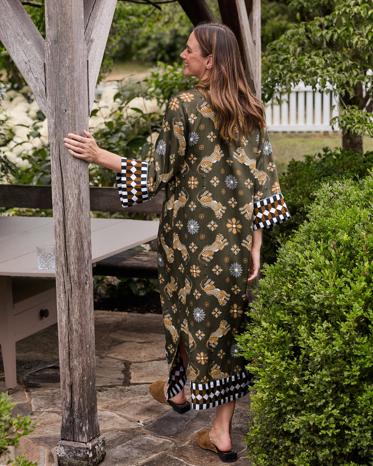 Back view of the Bagheera Kaleidoscope Kennedy caftan with leopard and floral print and geometric trim on the cuffs and hem.