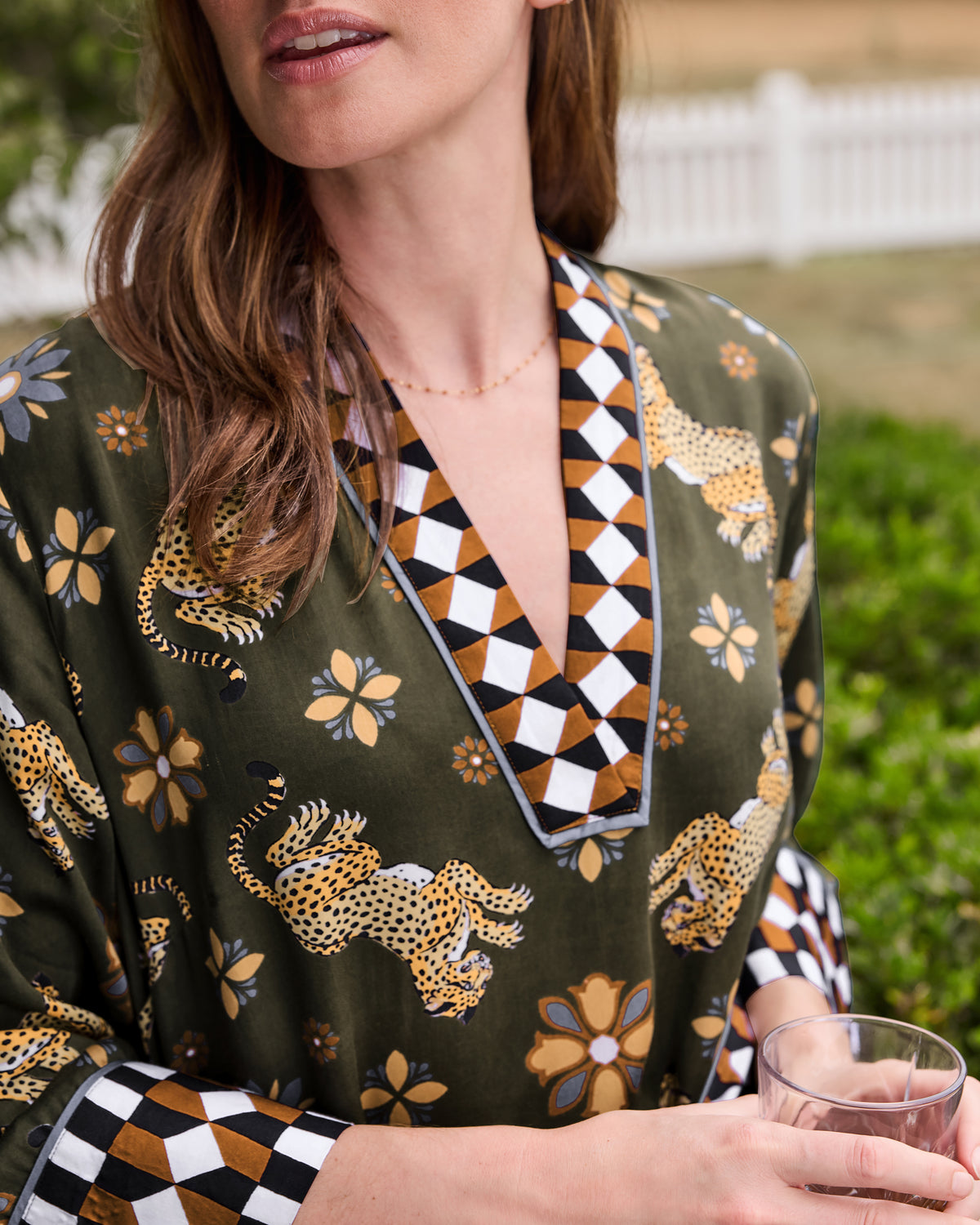 Close-up of the Bagheera Kaleidoscope Kennedy caftan showing the leopard and floral print, geometric neckline, and sleeve cuff trim.
