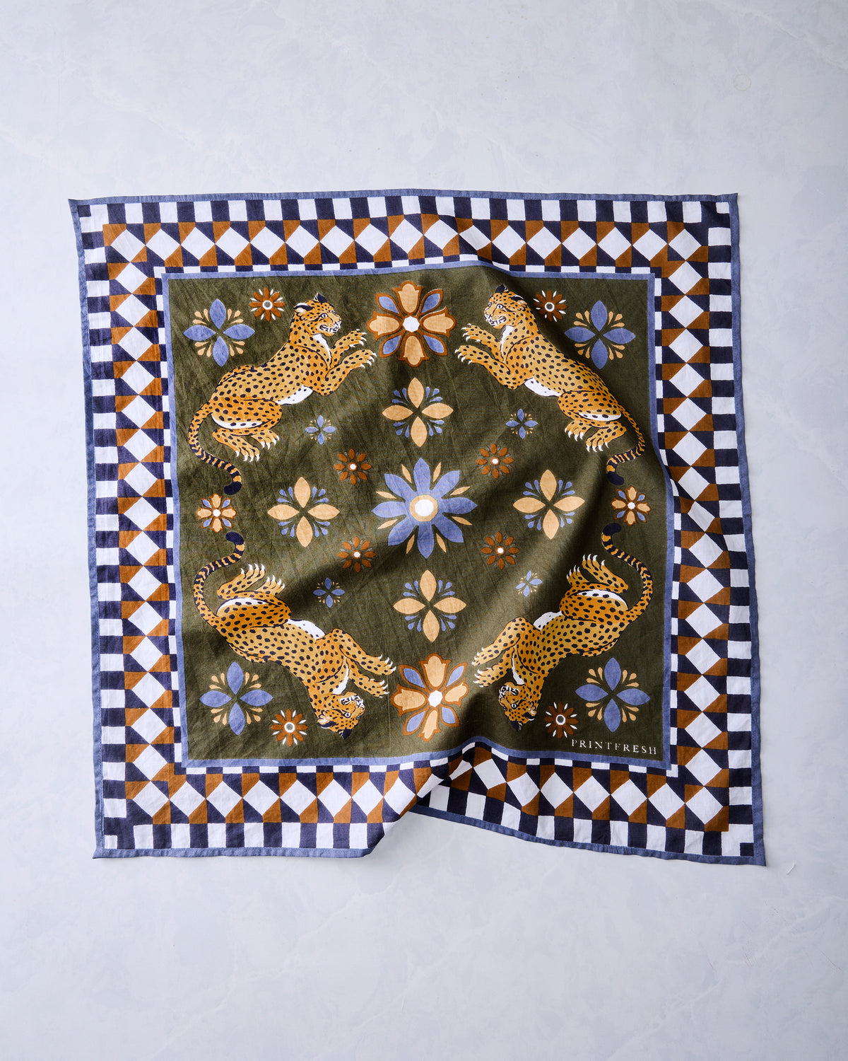 Olive square bandana scarf laid flat, featuring four leopards, flowers, and a geometric border