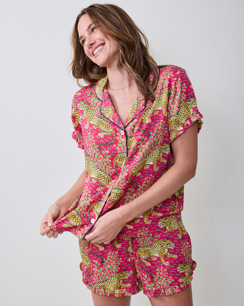Angled front view of a model wearing the hot pink Bagheera leopard-print ruffle short pajama set.