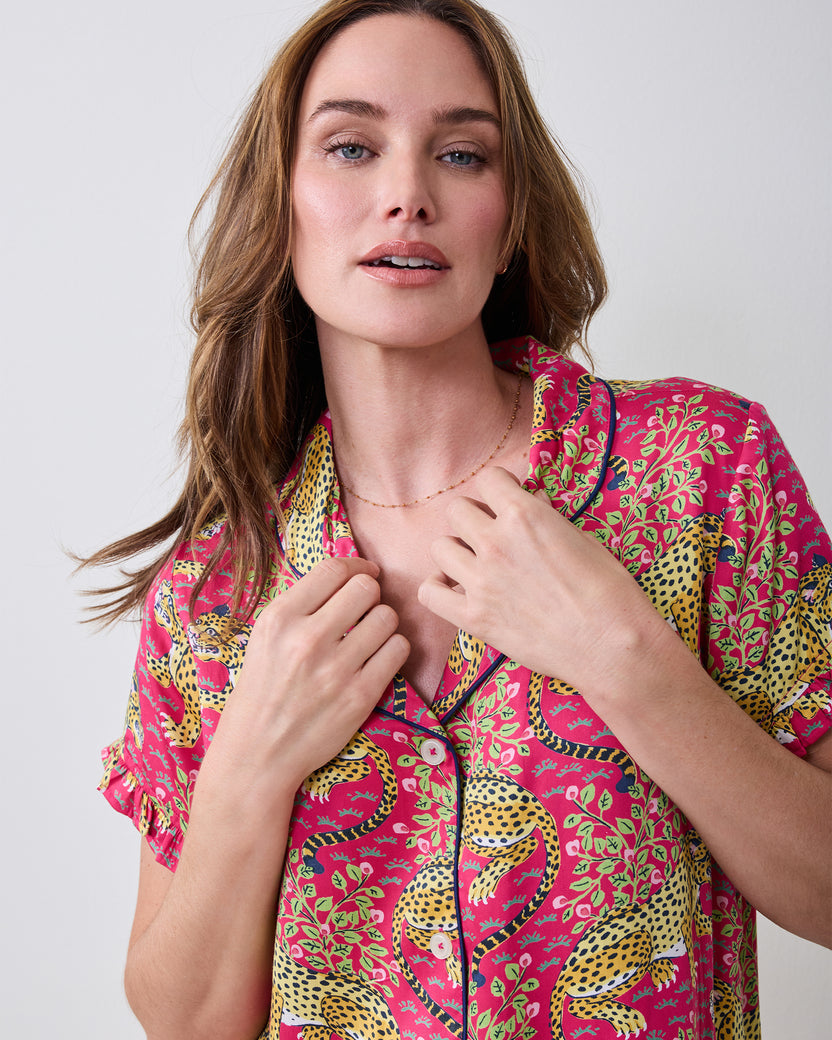 Close-up of the hot pink Bagheera pajama top showing the leopard print, collar, piping, and buttons.