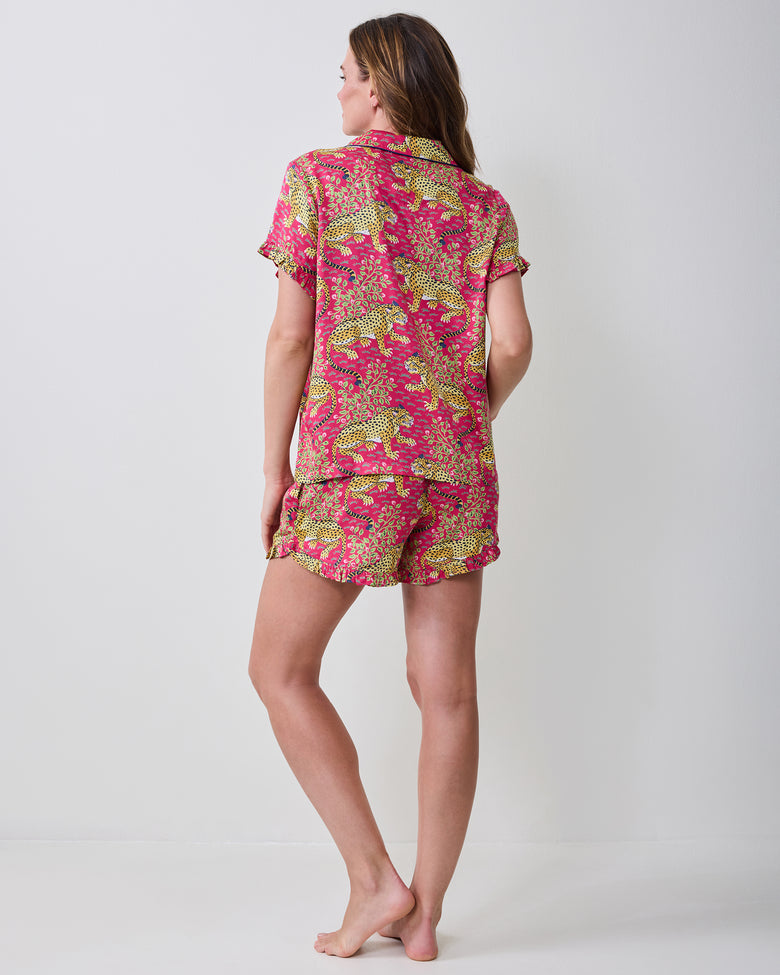 Back view of a model wearing the hot pink Bagheera leopard-print short pajama set with ruffled sleeve and short hems.