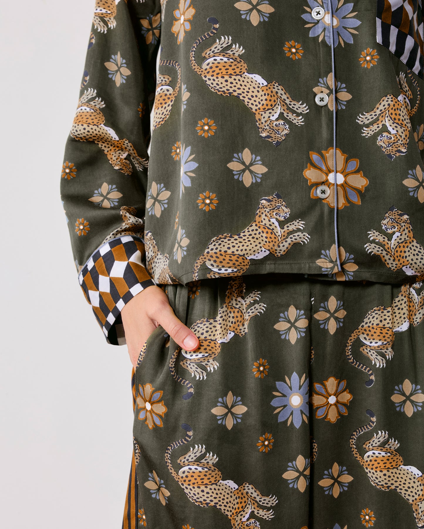 Close-up front view of the Rittenhouse set showing the button-front printed top, geometric-print cuff, and matching pants with a side pocket.