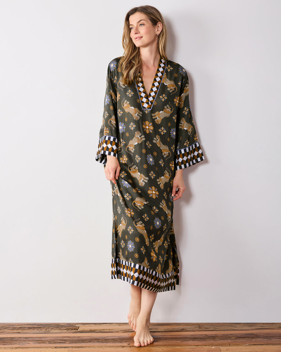 Full-length front view of the olive Bagheera Kaleidoscope Kennedy caftan with long sleeves, geometric-trimmed V-neck and cuffs, and a matching hem border.