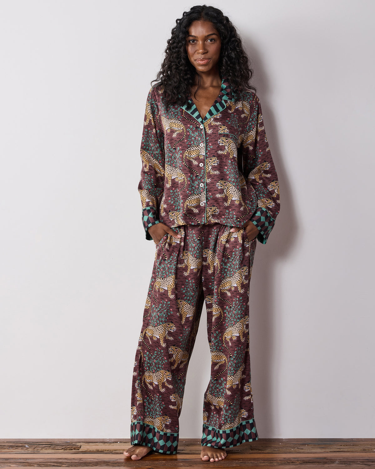 Full-length front view of a person wearing the raisin Bagheera leopard-print pajama set with a button-front top and wide-leg pants.