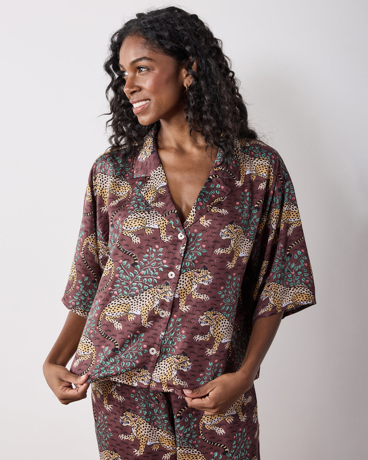 Bagheera Eco Satin Wildest Dreams Pajama Set in Raisin, showing a short-sleeve button-front top and matching wide-leg pants.