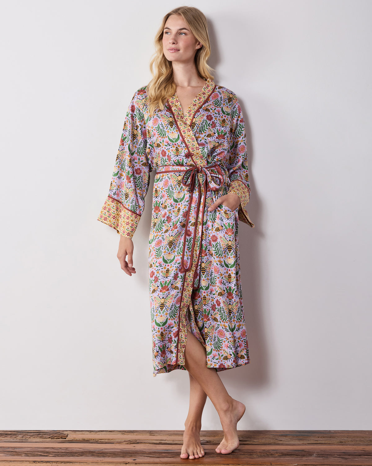 Front view of the lavender Bee Tapestry robe with contrasting trim, tie belt, pockets, and floral bee print.