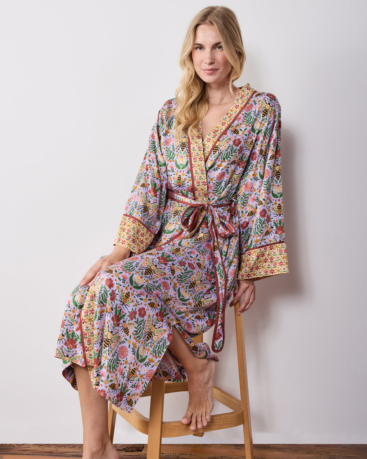 Front view of the lavender Bee Tapestry robe with long sleeves, tie belt, pockets, and floral bee print.