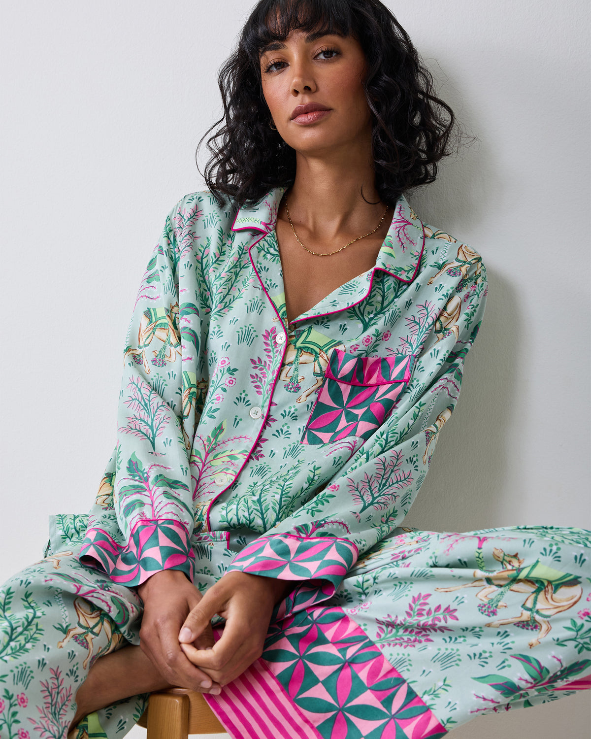 Close-up front view of the Avocado Camel's Courtyard pajama top, showing the notched collar, buttons, chest pocket, and patterned cuffs.