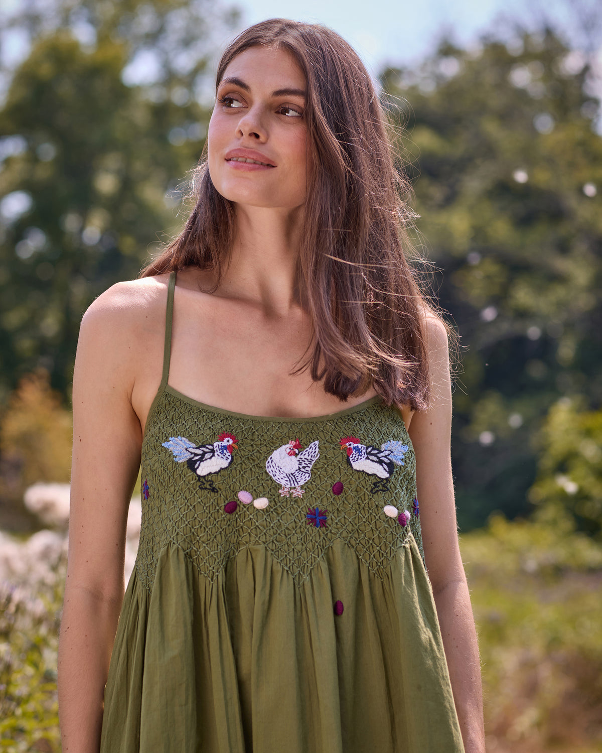 Olive chicken-and-rooster nightie with embroidered birds and flowers, shown outdoors.