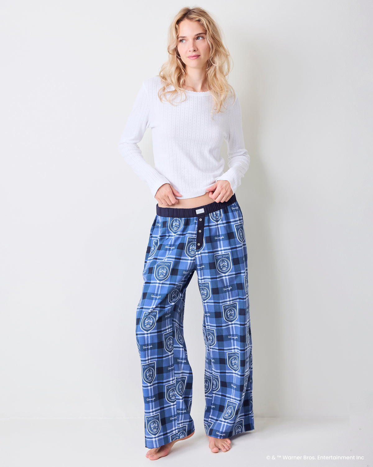 Model wearing Chilton Plaid wide-leg pajama pants with an elastic waistband and button fly.