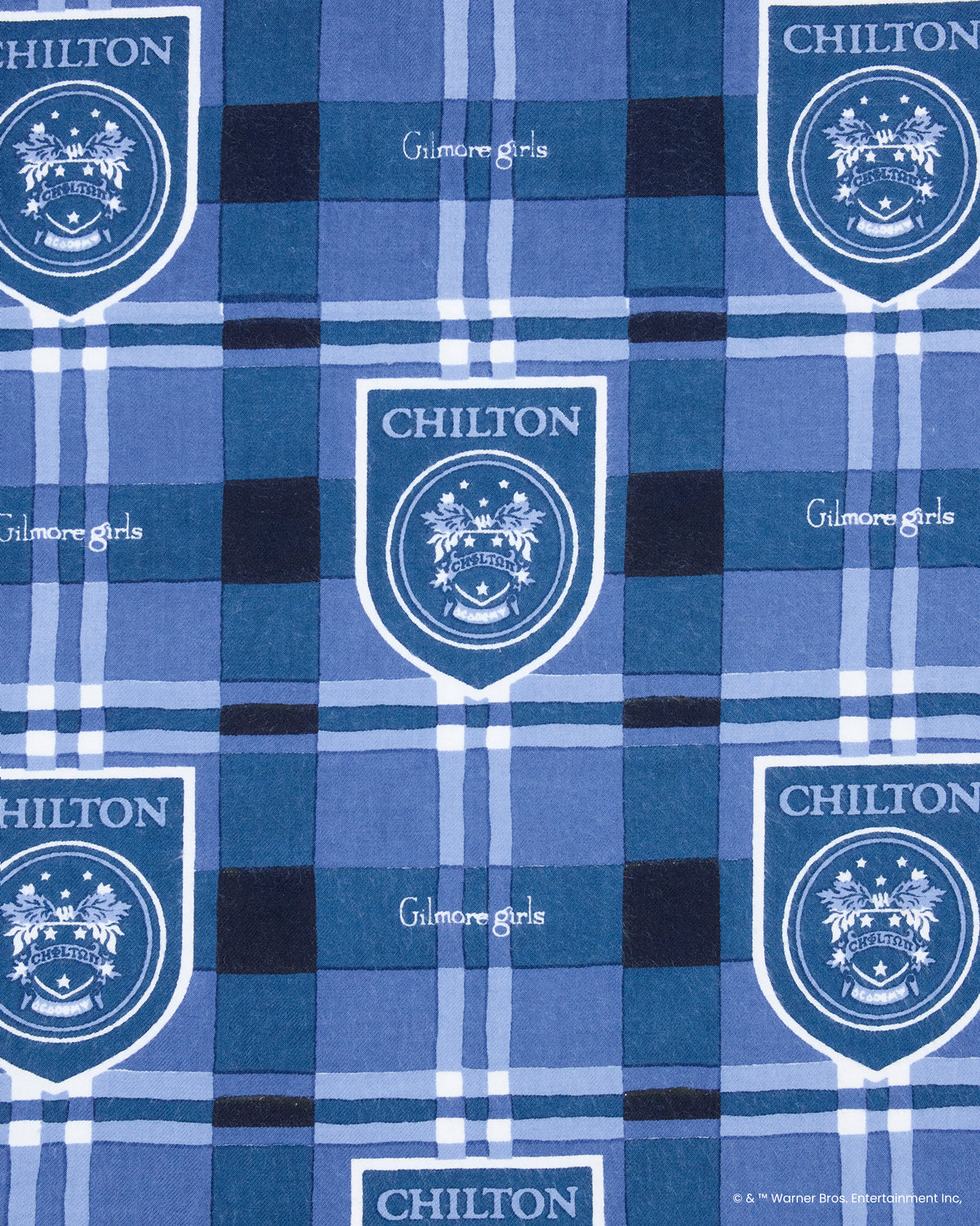 Blue plaid fabric print with repeated Chilton shield emblems and Gilmore Girls lettering.