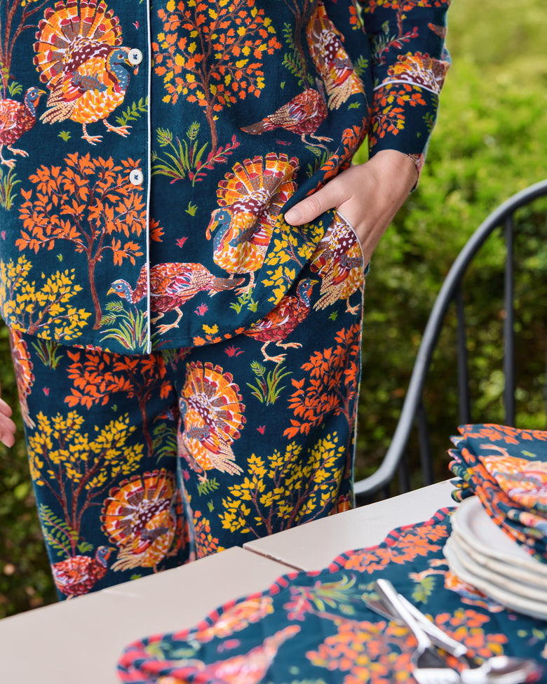 Close view of navy Turkey Trot long pajama set with turkey and autumn foliage print, showing the button-front top and pants pocket.