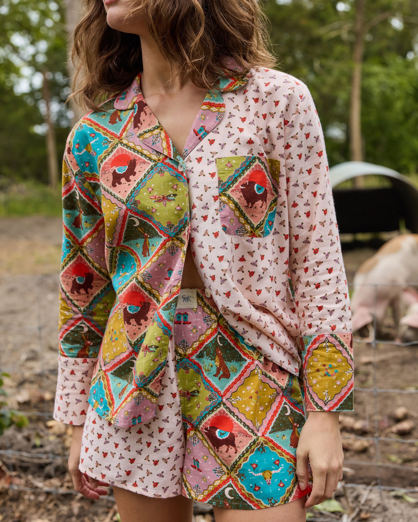 Close front view of a patterned pajama shirt with a collar, buttons, and chest pocket, paired with matching shorts.