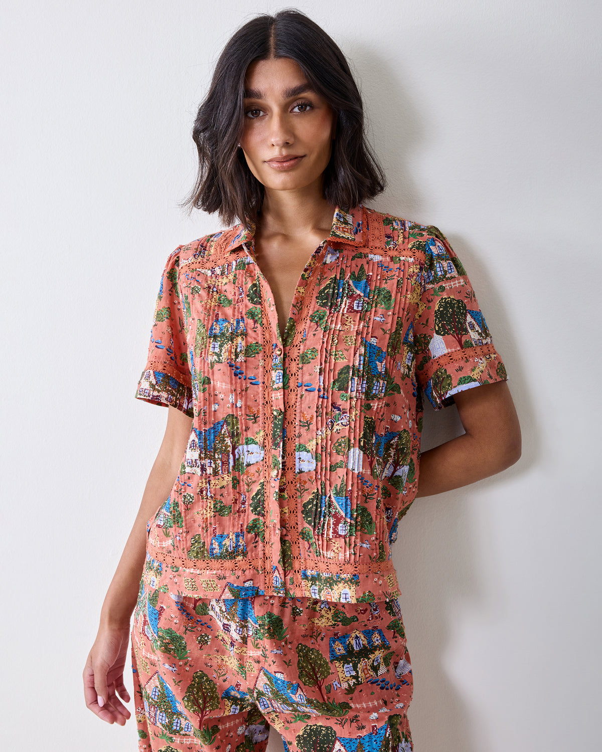 Front upper-body view of the Colette short-sleeve pajama top with a collar, button front, pleats, and lace trim.