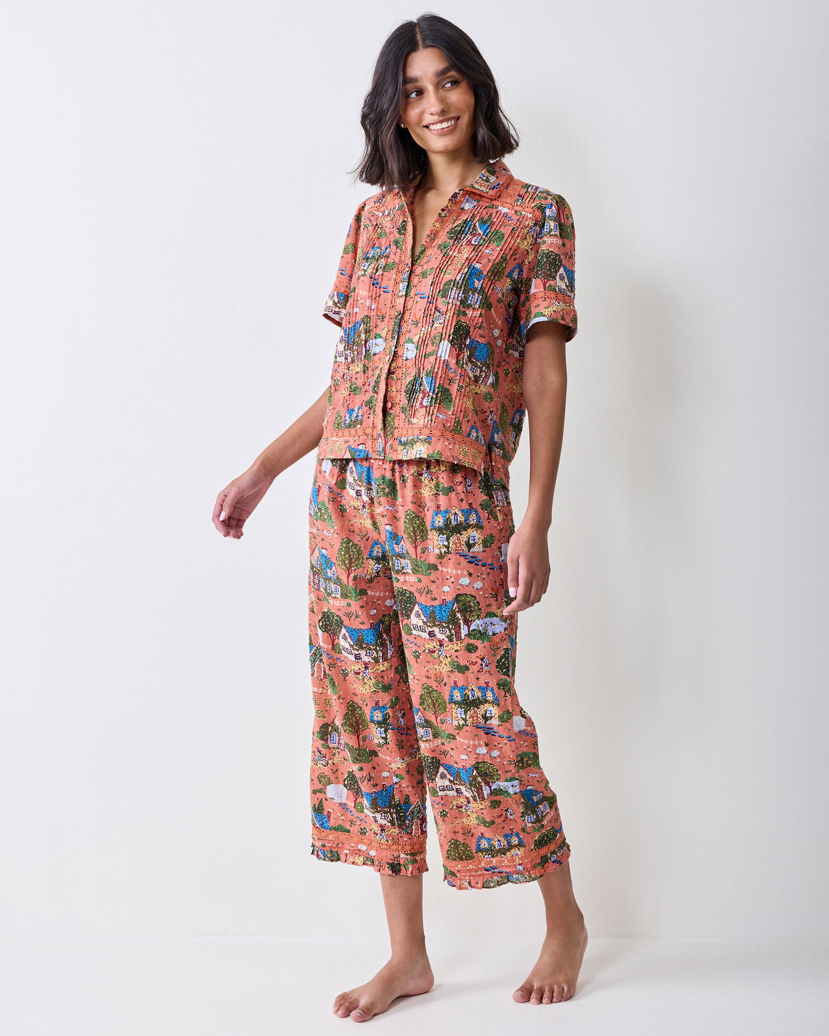 Front view of a person wearing the dusty rose Colette short-sleeve pajama set with cropped pants.