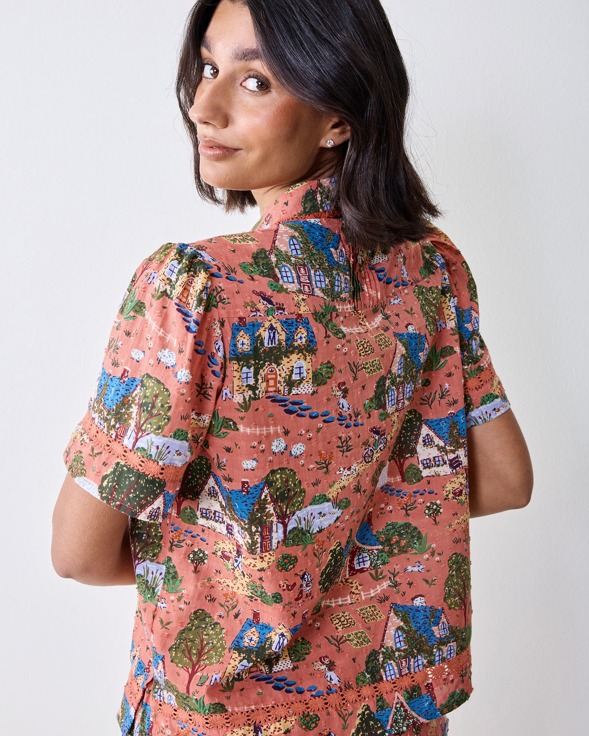 Back view of the Colette short-sleeve pajama top showing the collar, printed back, and lace-trimmed hem.