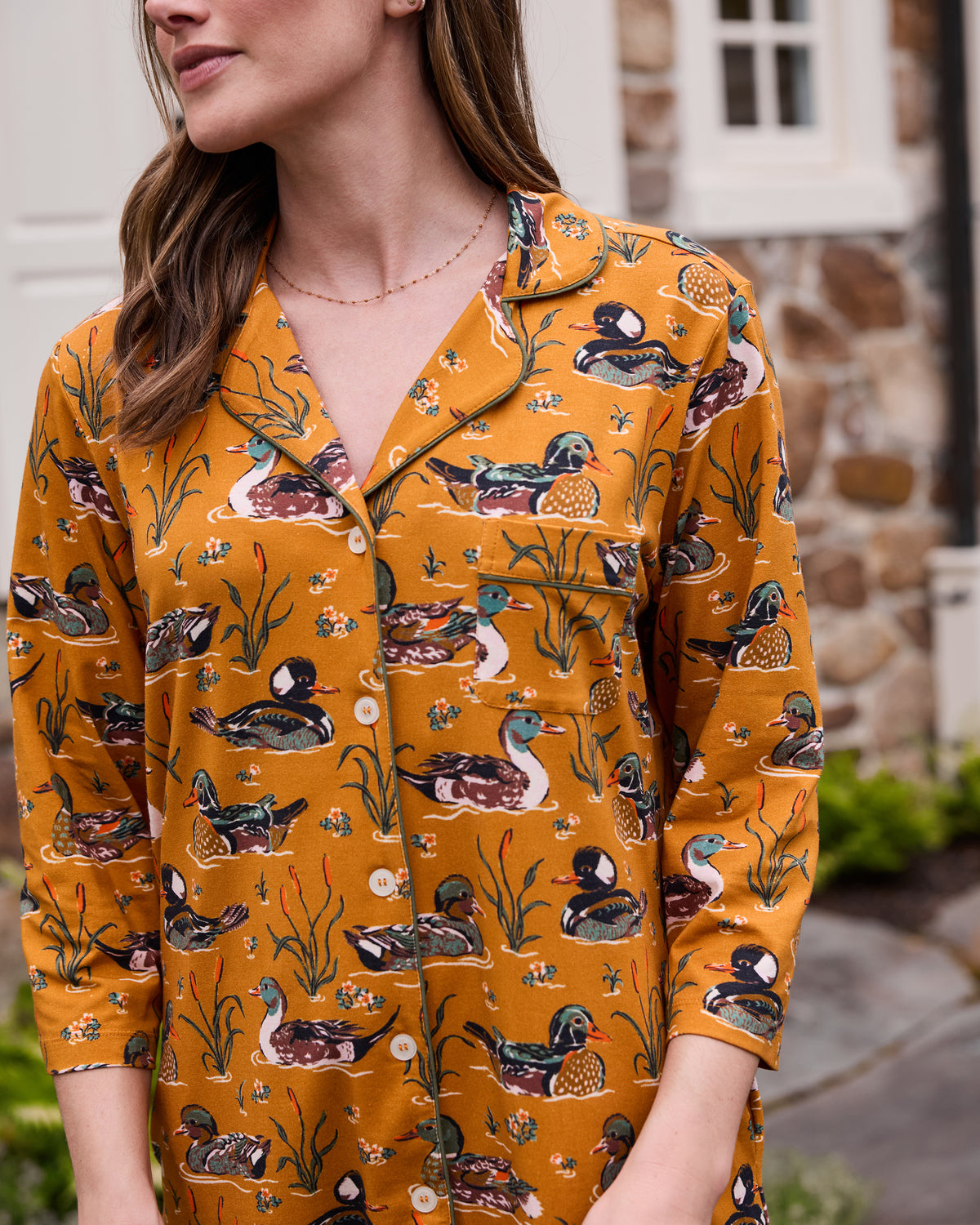 Close-up of the Duck Pond sleep shirt showing its button front, notched collar, chest pocket, three-quarter sleeves, and duck-and-reed print.